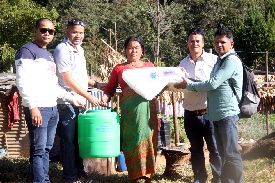 Pax Earth president Sujan Koirala, technical expert Rajan Gaire and other members distributing a drip irrigation kits and silpaulin to a farmer in Kot Timal