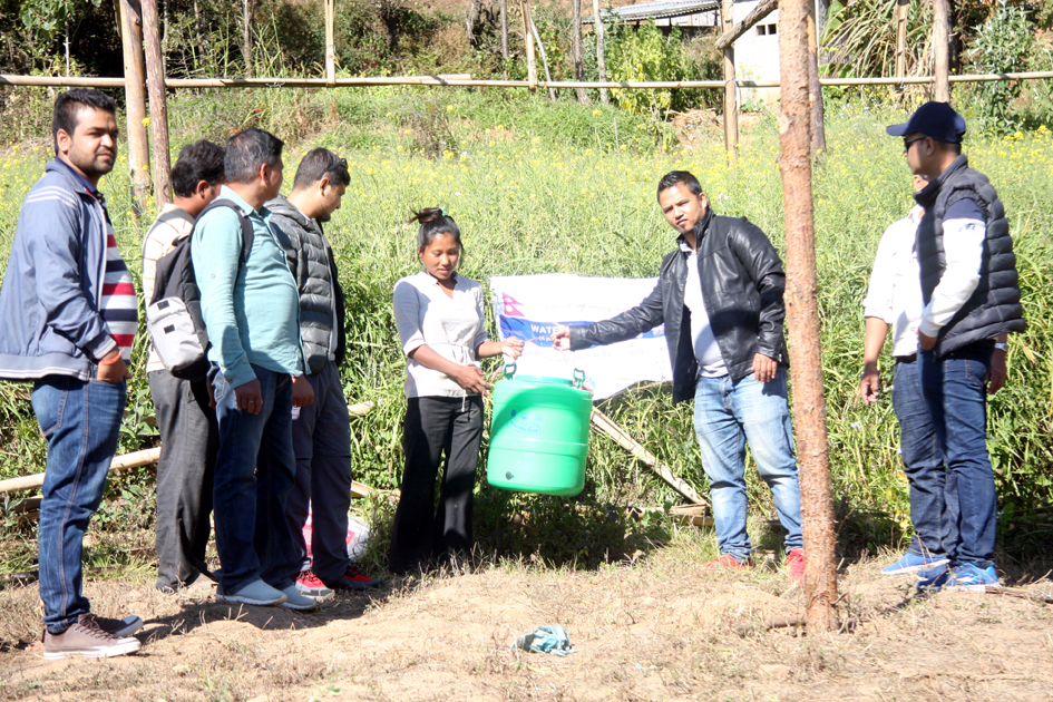 Pax Earth member Prabin Giri distributing a drip irrigation kits to a farmer in Kot Timal